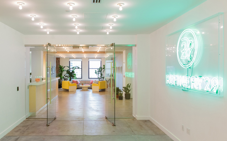 refinery29 new york office bright reception area neon