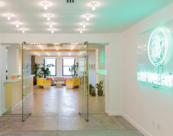 refinery29 new york office bright reception area neon