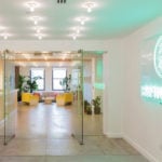 refinery29 new york office bright reception area neon