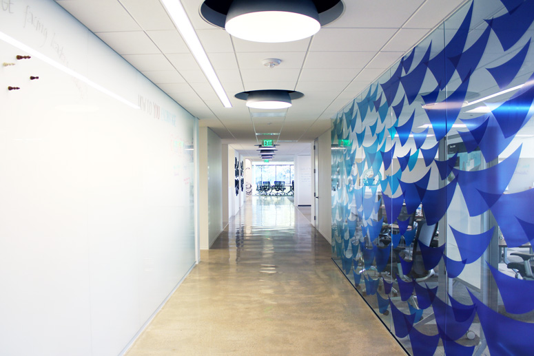 Floor-to-ceiling whiteboards stand ready to capture thoughts and musings when inspiration strikes in this colorful hallway.