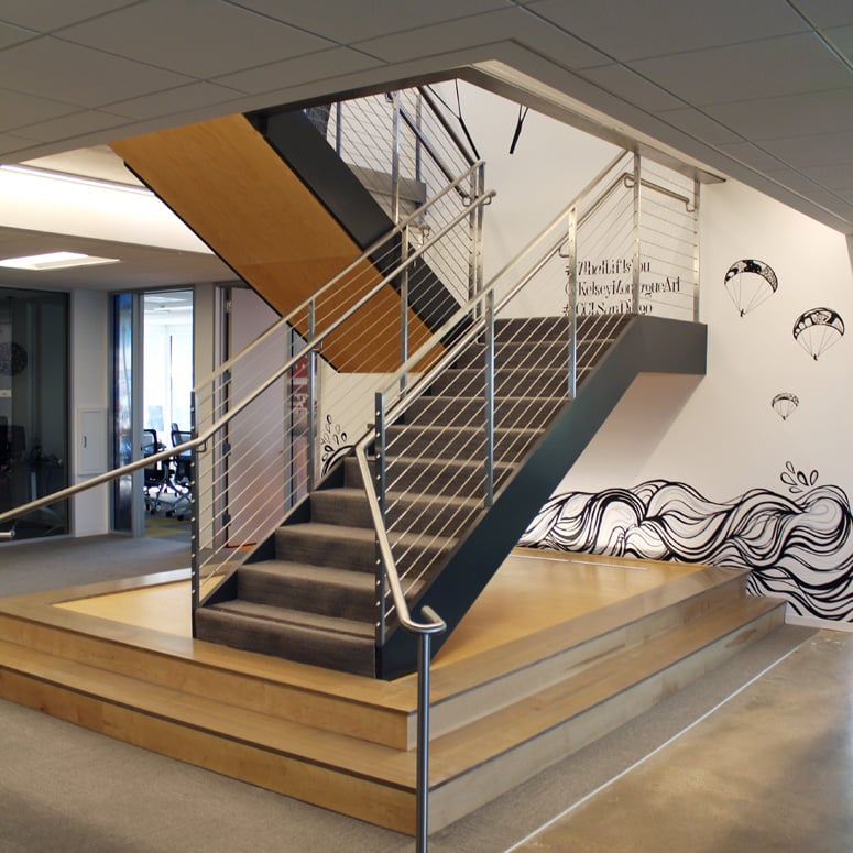 A custom mural surrounding the central staircase evokes the ocean and nearby glider port.