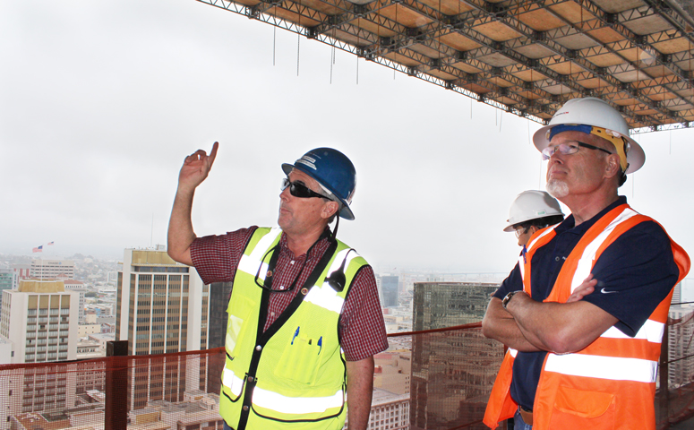 Project Superintendent Bill Rodgers (left) and Hughes Marino CM head Dean Petersen (right) discuss the temporary structure that was erected to help workers build the cantilevered canopy.